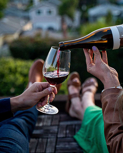 Concierge pouring wine for customers