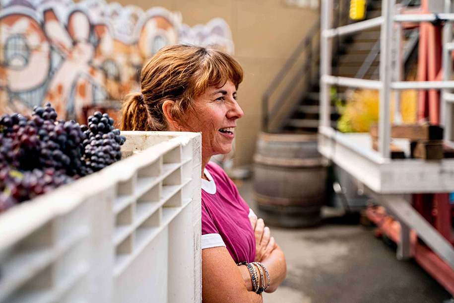 Tracey leaning on grape crate