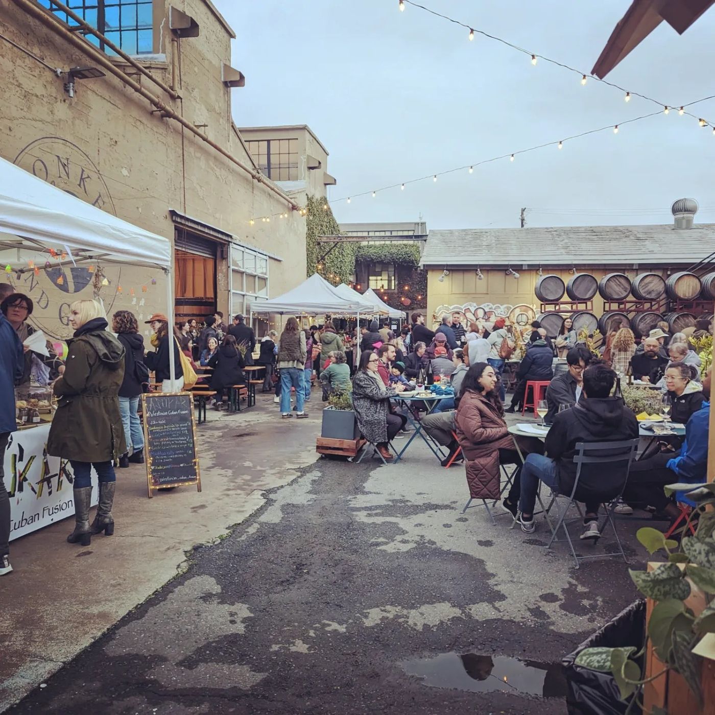 The courtyard under string lights with café tables