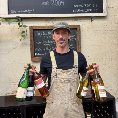 Michael with an armful of 2025 bottles