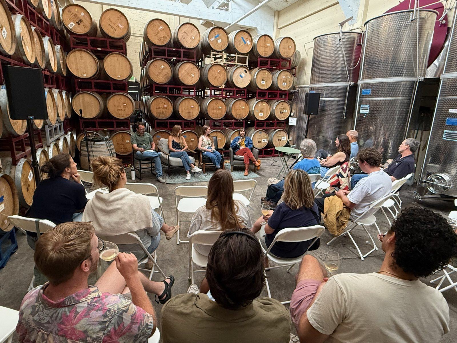 A panel discussion in the barrel room
